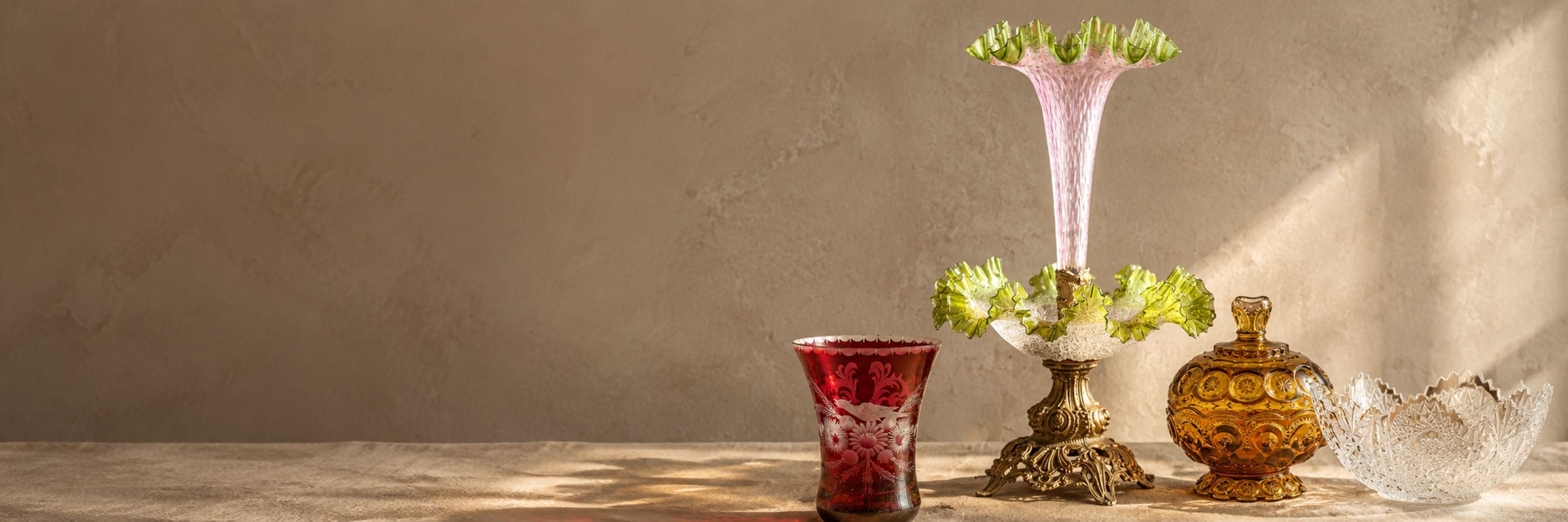 Antique glass epergne with pink and green ruffled glass, ruby etched vase, amber glass jar and cut crystal bowl